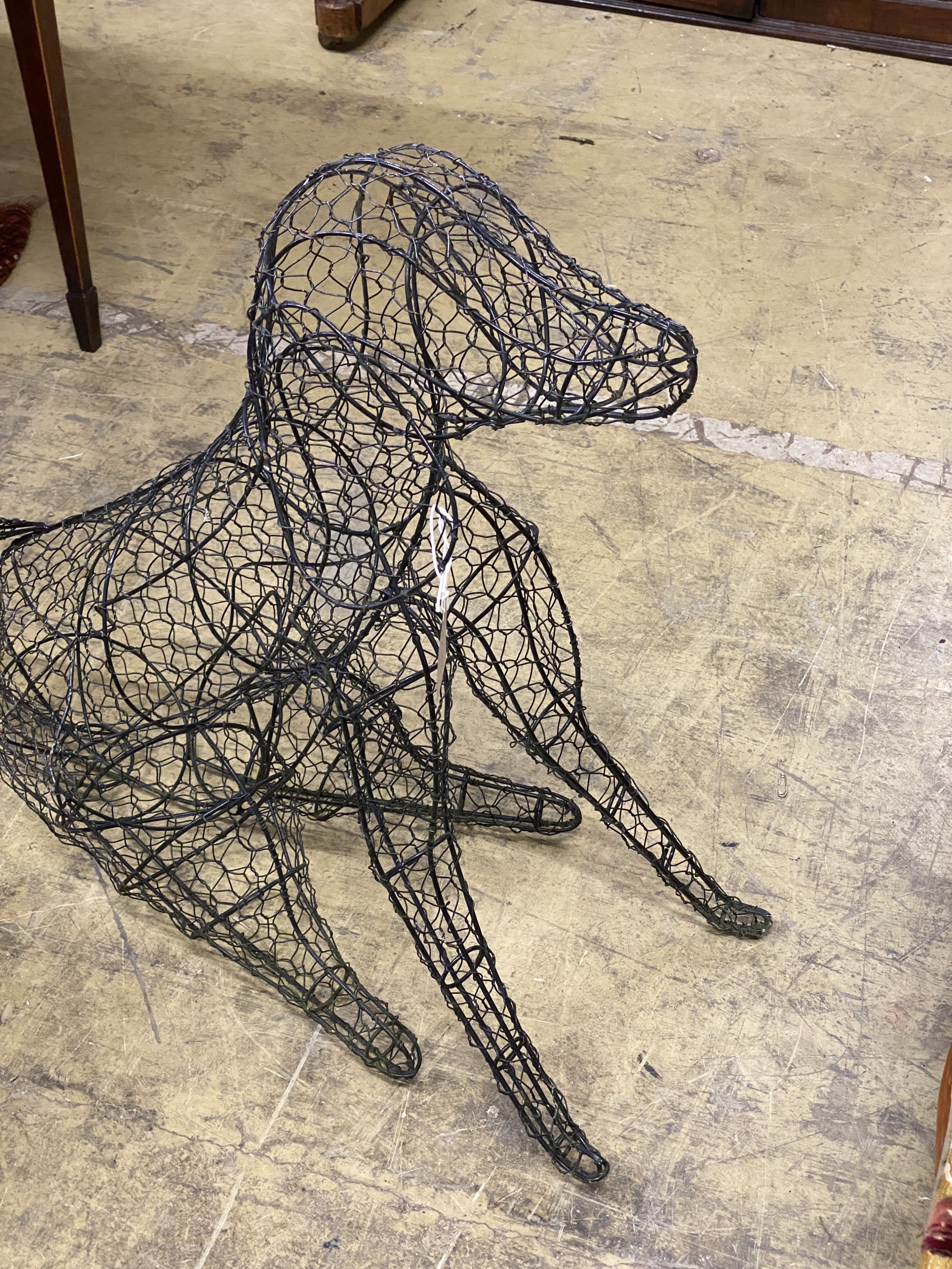 A wirework seated dog garden ornament, height 70cm